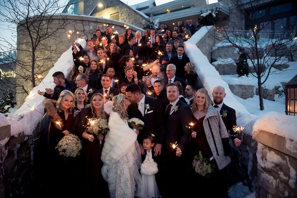 sparkler photo of whole wedding on the front steps at the Cambridge Mill. 