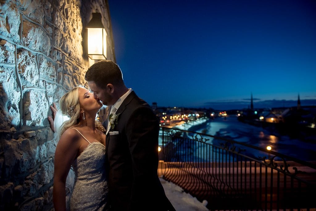 bride and groom kissing on the balcony at the Cambridge Mill