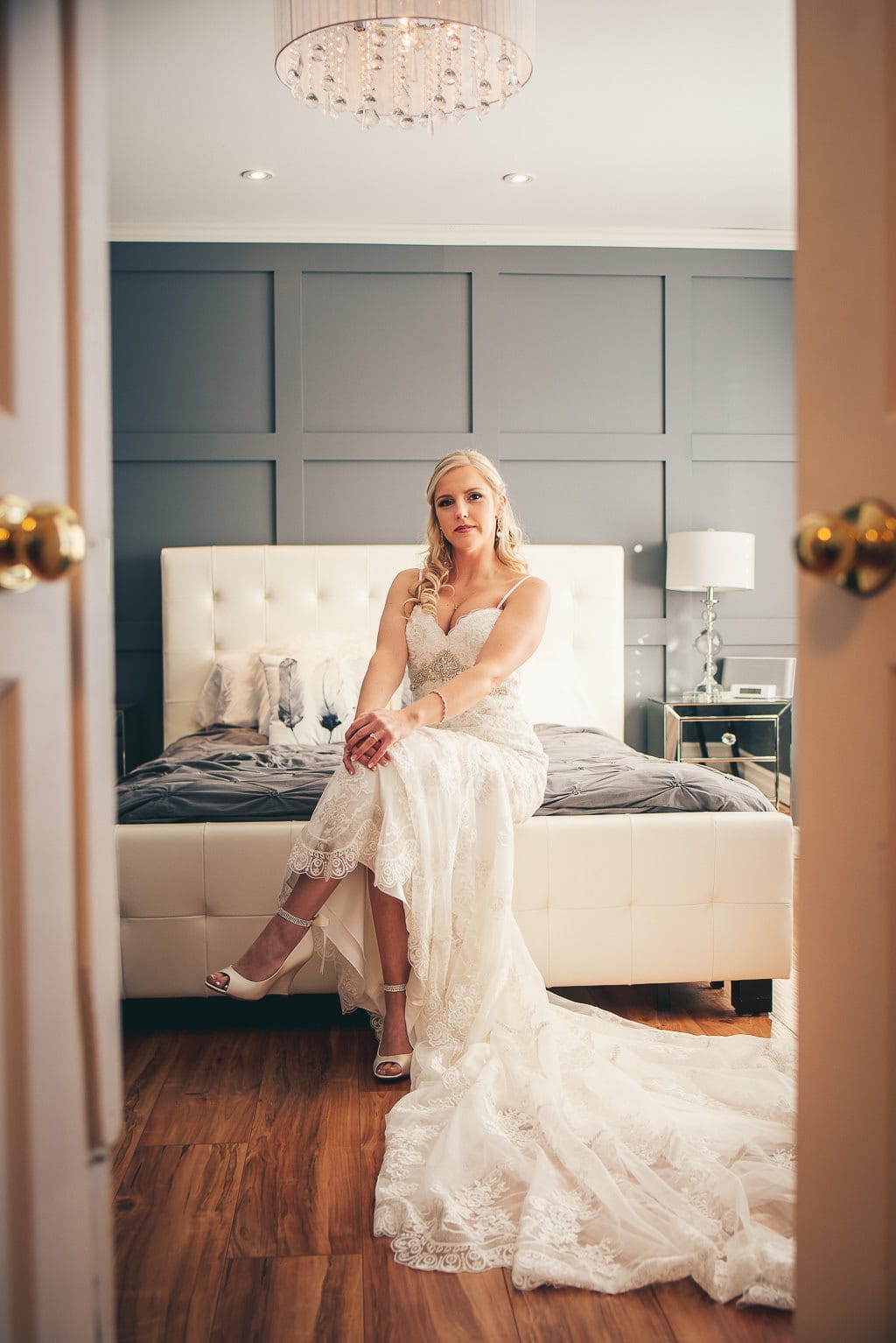 Bridal portrait, bride sitting on her bed