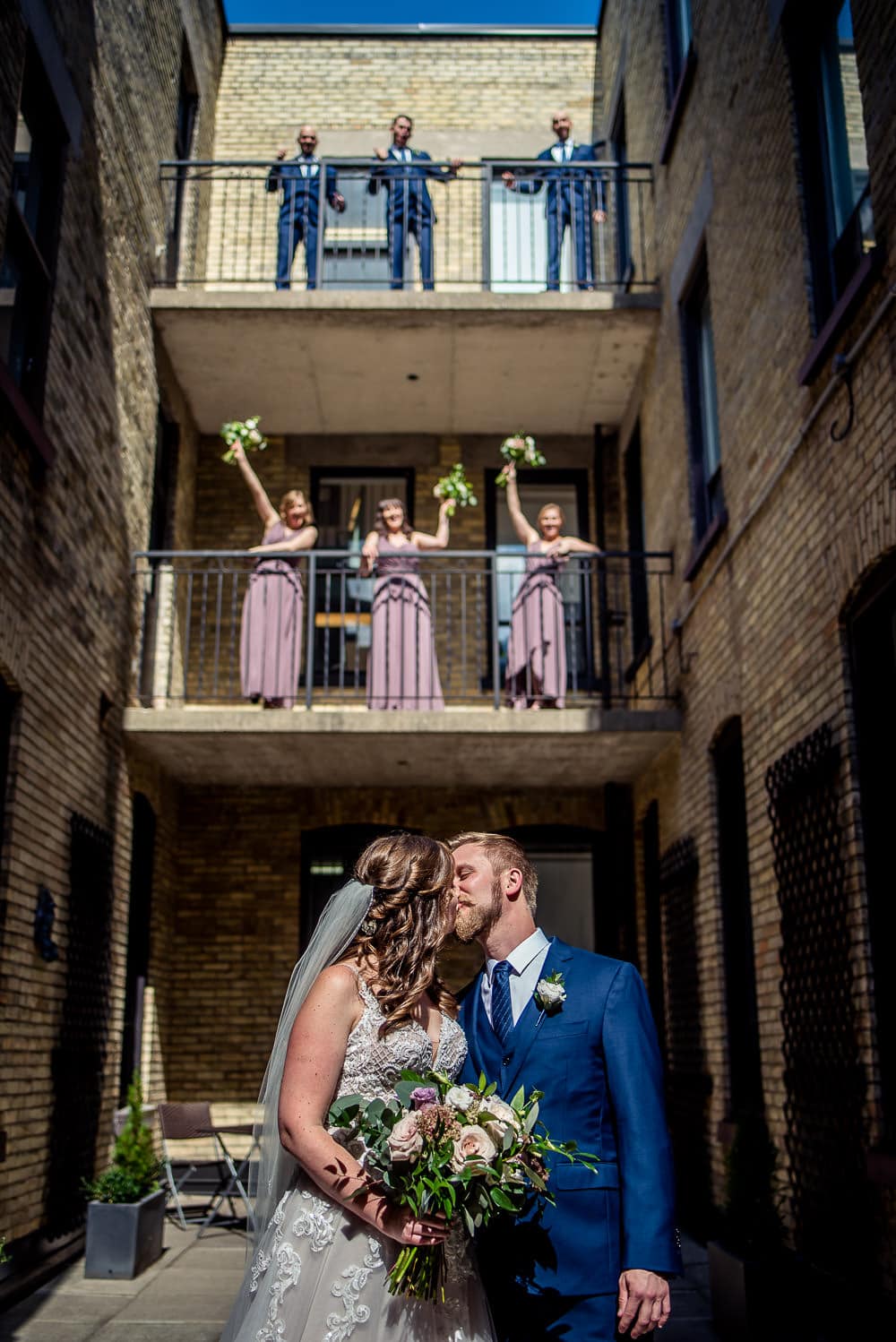 bridal party cheering from balcony of walper hotel wedding