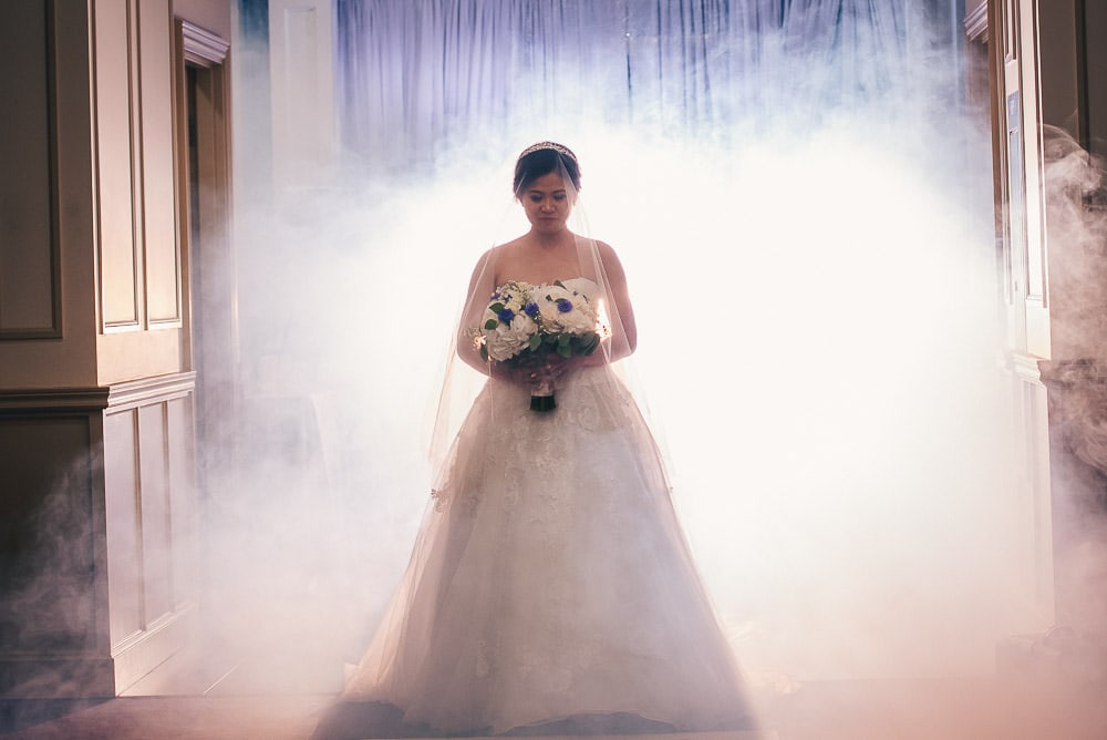 Bride coming down aisle at her wedding at brookside banquet centre with fog machine 