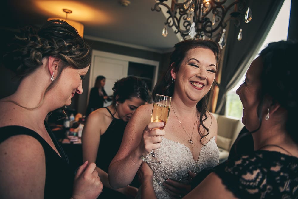 bride laughing while getting ready at Elmhurst Inn for wedding