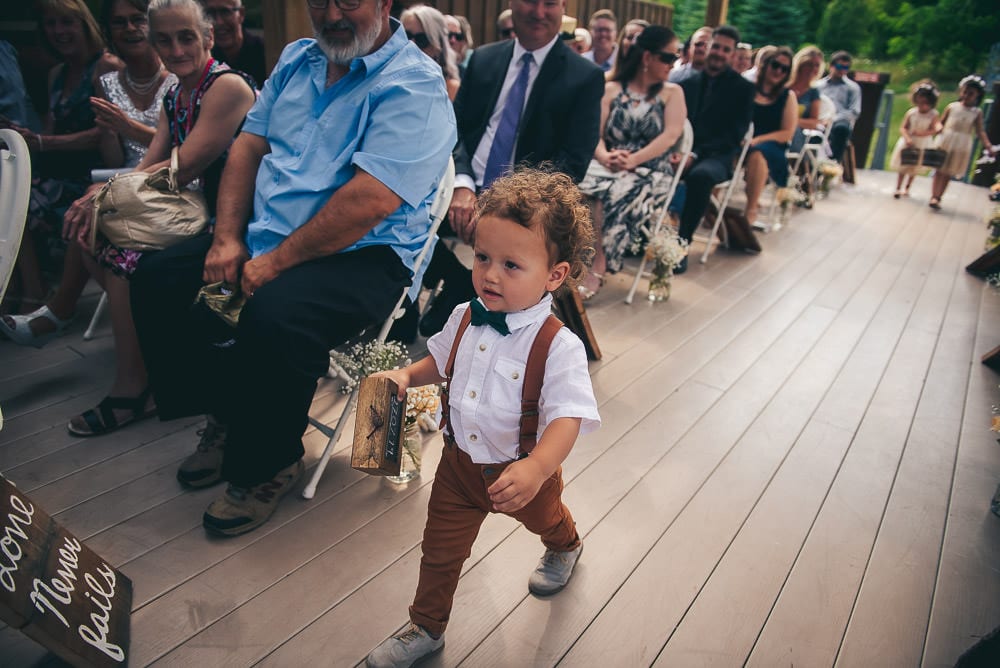 ring bearer marching down the aisle at pine Vally chalet