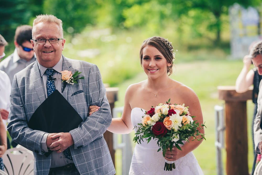 father walking daughter down the aisle at wedding at pine Vally chalet Kitchener