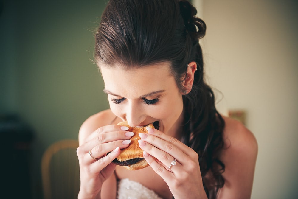 bride enjoying a burger before her wedding