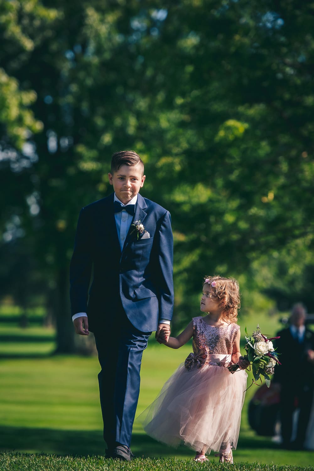nick and Courtneys kids walking down the aisle during wedding at craigowan golf club