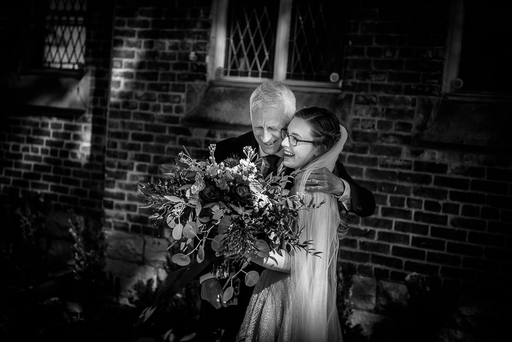 father hugging daughter before her wedding at elsie Perrin williams estate in London Ontario