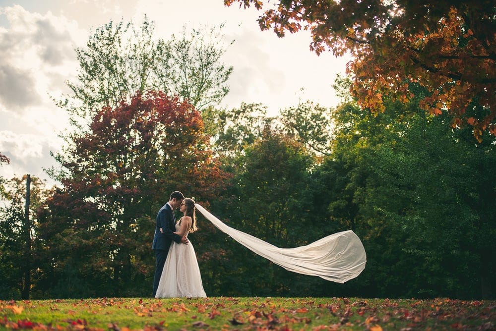 bride and groom photo at elsie Perrin wedding with long veil in London Ontario