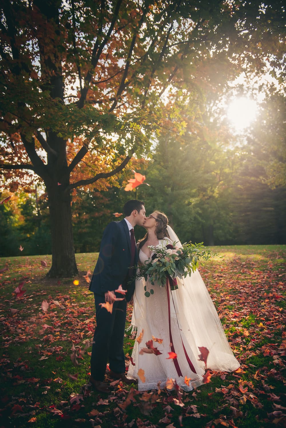 bride and groom fall themed photo at elsie Perrin wedding with long veil in London Ontario