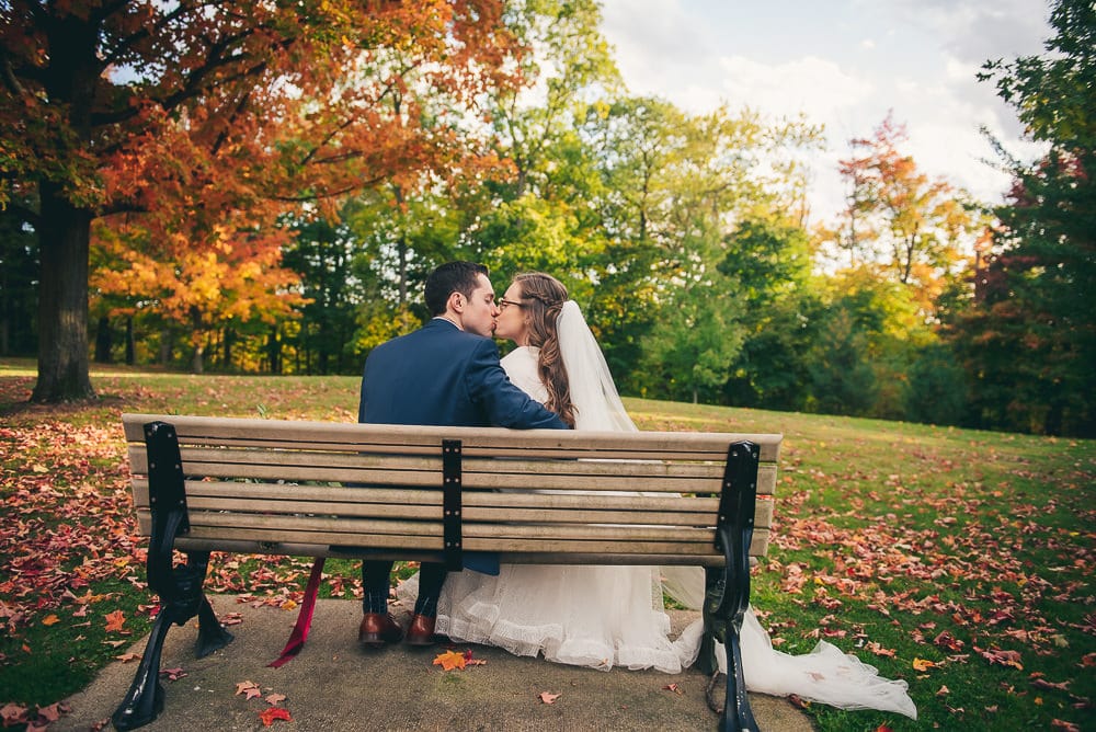 bride and groom fall themed photo at elsie Perrin wedding with long veil in London Ontario